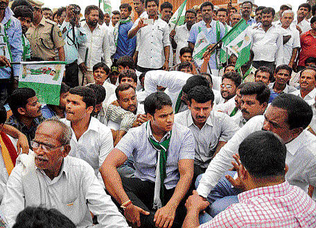 Nikhil Gowda, son of former chief minister H D Kumarswamy, and JD(S) workers stage a protest in front of the toll plaza on airport road demanding rollback of the recently revised toll, in the City on Monday.  DH&#8200;Photo