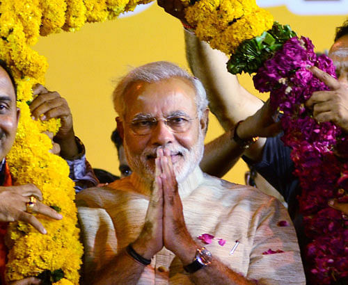 Narendra Modi is garlanded by Gujarat BJP leaders at a public meeting in Ahmedabad on Tuesday. PTI