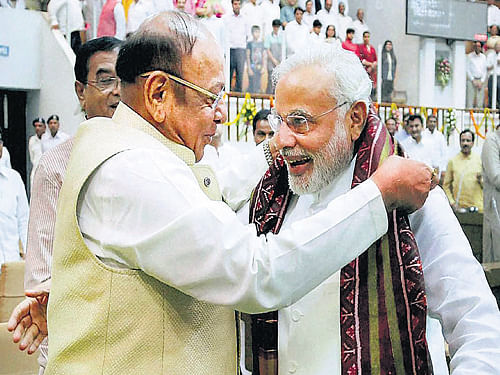 Prime Minister-elect and Gujarat Chief Minister Narendra Modi is presented a shawl by senior Congress leader Shankersinh Vaghela during the special session of the state Assembly in Gandhinagar on Wednesday. PTI