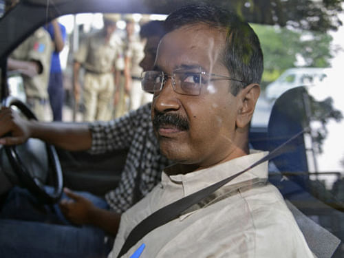 Arvind Kejriwal looks out from inside his car as he  arrives at a court in New  Delhi on Wednesday. Reuters