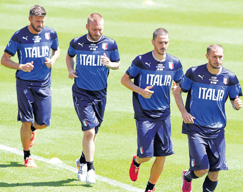 The Italian football team sweats it out during a training session at Florence. AP photo