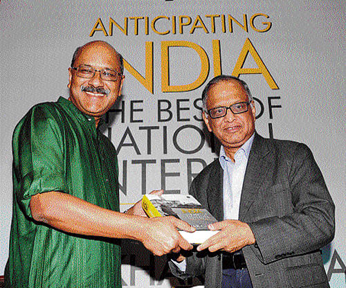 Infosys Founder and Chairman N R Narayana Murthy hands over a copy of the book 'Anticipating India: The Best of National Interest' to its author and The New Indian Express Group Editor-in-Chief Shekhar Gupta after releasing it at a function at Leela Palace in City on Saturday. DH PHOTO