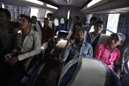 Fishermen from India sit in a bus after their release from Karachi's District Jail Malir May 25, 2014. Pakistani authorities on Sunday released 58 detained Indian fishermen, who were imprisoned for illegally venturing into the country's territorial waters, and a civilian from District Jail Malir as a goodwill gesture between the two countries ahead of the swearing-in ceremony of the new Indian government led by Narendra Modi on Monday, local media reported. REUTERS