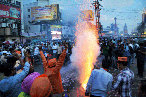 Celebrations erupted in the national capital and other parts of the country as Narendra Modi was sworn in as Prime Minister this evening with BJP workers and supporters distributing sweets and setting off firecrackers while greetings poured in for the new government. PTI photo