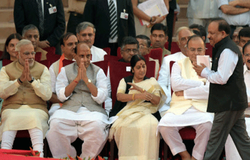Newly sworn-in Prime Minister Narendra Modi and other ministers look on as Harsh Vardhan walks to take oath at the swearing-in ceremony of the NDA government at Rashtrapati Bhavan in New Delhi on Monday. PTI Photo