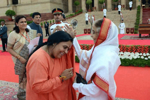Newly sworn-in minister Uma Bharti seeks blessings of former President Pratibha Patil at the swearing-in ceremony of the NDA government at Rashtrapati Bhavan in New Delhi on Monday. PTI Photo