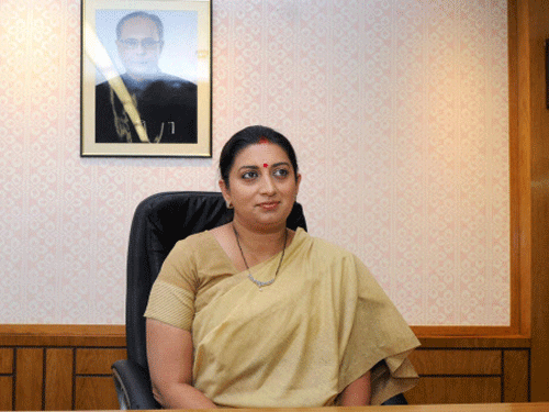 Smriti Zubin Irani takes charge as Union Minister for Human Resource Development at her office in New Delhi on Tuesday. PTI Photo