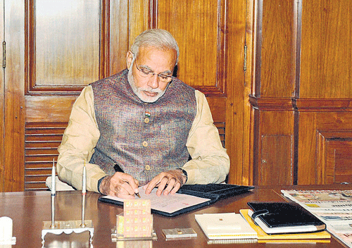 Prime Minister Narendra Modi takes charge at the PMO in New Delhi on Tuesday. PTI photo