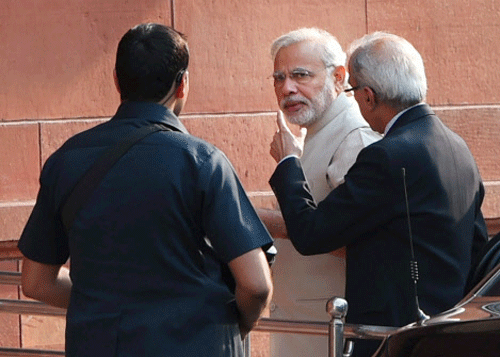 Prime Minister Narendra Modi with Principal Secretary Nripendra Misra heading to chair the first Cabinet Meeting of his government in New Delhi on Tuesday. PTI Photo