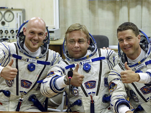 European Space Agency's astronaut Alexander Gerst, left, Russian cosmonaut Maxim Suraev, center, and NASA astronaut Reid Wiseman, crew members of the mission to the International Space Station, gesture prior the launch of Soyuz-FG rocket at the Russian leased Baikonur cosmodrome in Kazakhstan. AP photo
