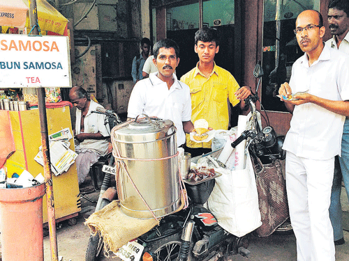 Customers at 'Manjunath Tea Motorcyle'. DHNS