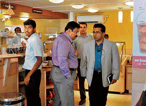 spot inspection: CID Deputy Inspector General of Police Soumendu Mukherjee and his team visit the coffee shop on Cunningham Road in Bangalore on Friday. dh Photo