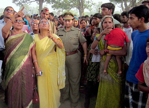 A team of National Women commission at the village to get all the relevant information from the villagers about the Badaun rape and double murder case, in Badaun on Friday. PTI Photo