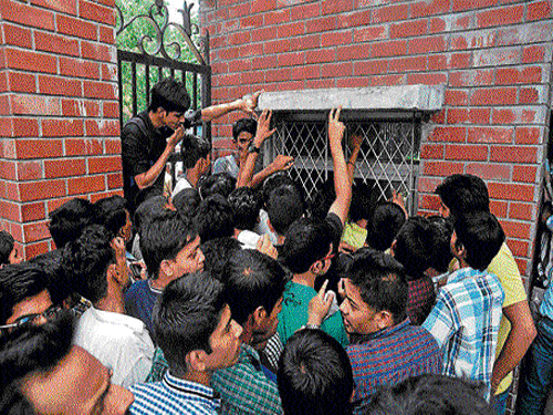 On the first day of DU admission, students gather outside the window selling forms at Daulat Ram College. DH Photo
