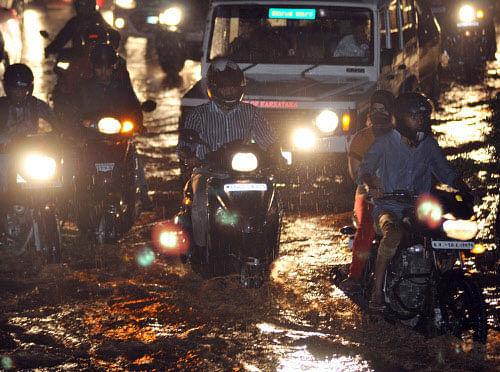 Heavy rains, accompanied by gusty winds and thunder, hit many parts of Bangalore for over four hours on Monday night, disrupting life and exposing the poor monsoon preparedness of the government agencies.  DH photo