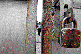 A security guard on patrol inside the closed premises of the Uttarpara plant of Hindustan Motors on Monday. Reuters