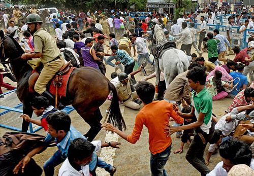 A horse-mounted police man evicting the mob from the front of Eden Garden during a felicitation programme of IPL winning Kolkata Knight Riders team, in Kolkata on Tuesday. PTI Photo