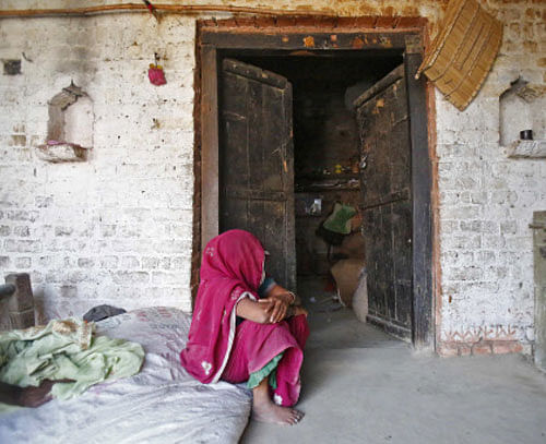 The veiled mother of one of the two teenage girls, who were raped and hanged from a tree, weeps outside her house at Budaun district  Uttar Pradesh. Reuters photo for representation purpose