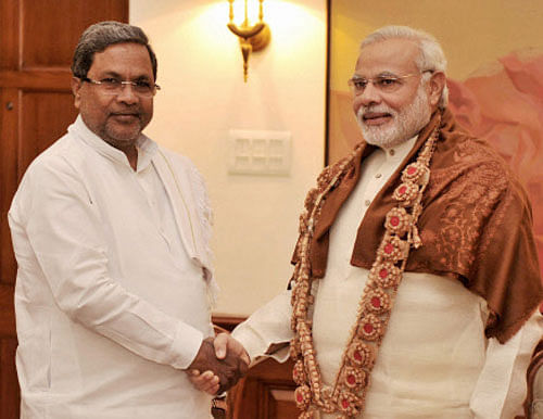Prime Minister Narendra Modi with Karnataka Chief Minister Siddaramaiah at a meeting in New Delhi on Wednesday. PTI Photo