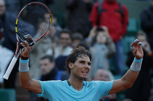 Spain's Rafael Nadal celebrates winning the quarterfinal match of the French Open tennis tournament against compatriot David Ferrer at the Roland Garros stadium, in Paris, France, Wednesday. AP photo