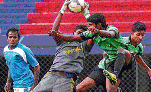 smart save Hari, custodian of RWF, stops an attempt on goal by South United's Senthii and Subash during their Super  Division football league match on Thursday. DH PHOTO