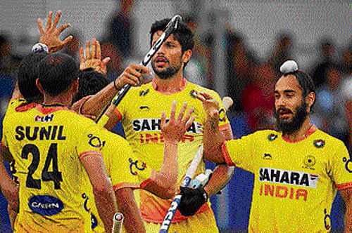 Rare moment: Indian players celebrate a goal against Malaysia during their hockey World Cup tie on Saturday.
