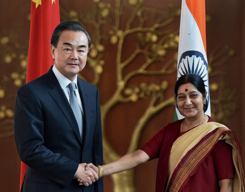 External Affairs Minister Sushma Swaraj shakes hands with her Chinese counterpart, Wang Yi, ahead of their meeting in New Delhi on Sunday. PTI Photo