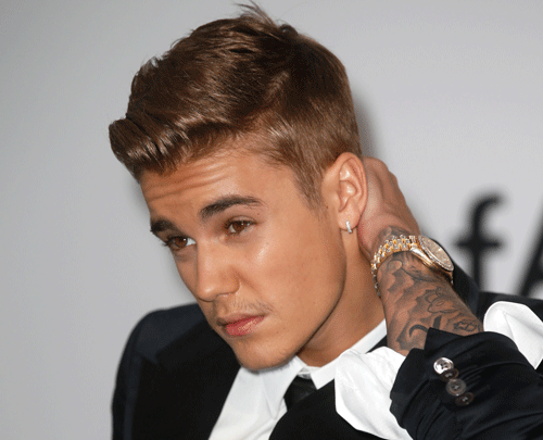 Troubled singer Justin Bieber has reportedly turned to god after his racist videos surfaced and tried to wash away his sins with a baptism performed in a bathroom. Reuters file photo