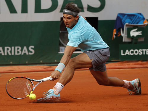 Rafael Nadal clinched his ninth French Open and 14th career Grand Slam title on Sunday with a brutal 3-6, 7-5, 6-2, 6-4 victory over a battling Novak Djokovic. AP photo
