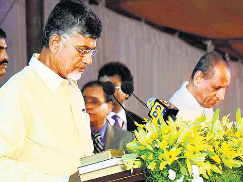 Governor of Andhra Pradesh ESL Narasimhan administers the oath to N Chandrababu Naidu on Sunday. PTI