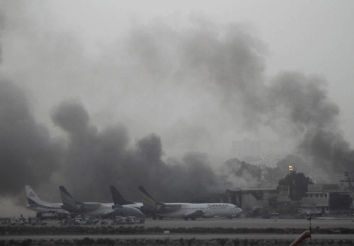 Smoke billows from Jinnah International Airport in Karachi June 9, 2014. Reuters photo