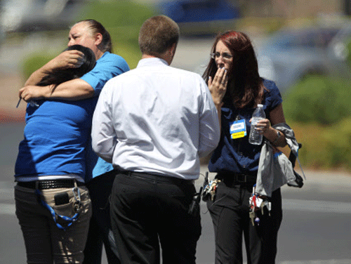 Wal-Mart employees hug outside a store after a shooting at the store and a nearby CiCi's Pizza in Las Vegas. AP photo