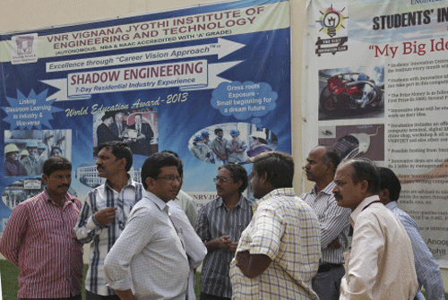 College staff working at VNR Vignana Jyothi Institute of Engineering and Technology, gather around in the college premises on the outskirts of Hyderabad. AP photo