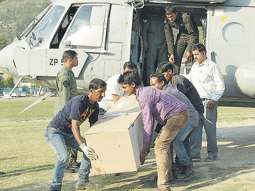 The body of one of a victim is loaded onto an Army chopper. Reuters