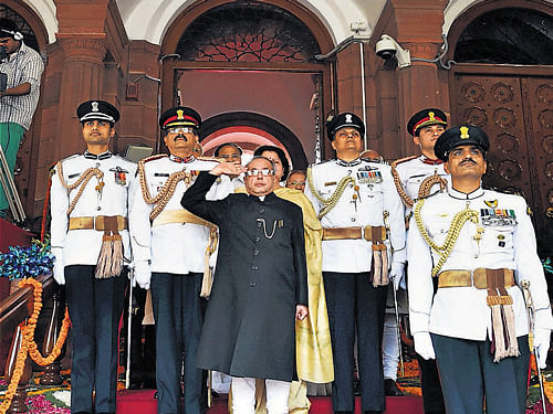 President Pranab Mukherjee taking salute from his guards before his  ceremonial procession to address the joint session of Parliament in New Delhi on Monday. PTI