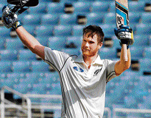 Two in a row: Jimmy Neesham celebrates after scoring a century against West Indies on Monday. AP