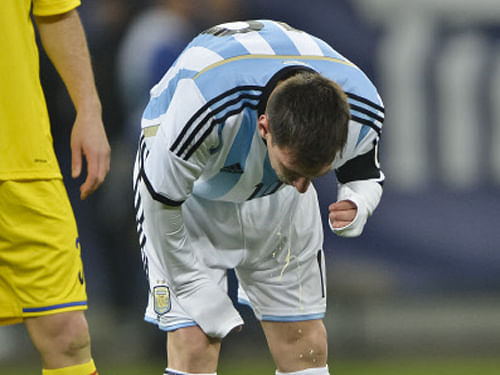 Shortly after coming on as a second-half sub in Argentina's last World Cup warm-up, Lionel Messi doubled over and appeared to vomit on the pitch. AP file photo