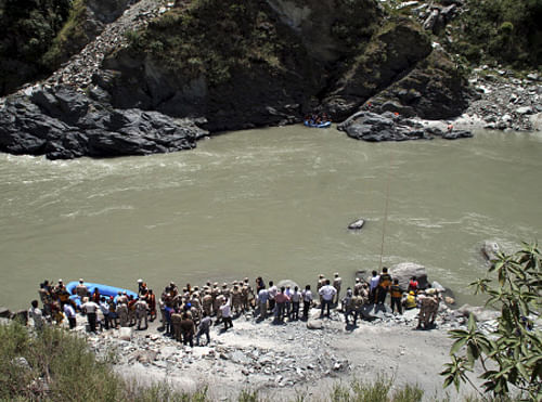 Rescuers scouring the Beas river where a wall of water washed away 24 engineering students are battling strong rapids and low visibility. AP photo