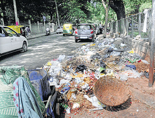 Garbage lies uncleared near a primary health centre in Palace Guttalli on Wednesday. DH PHOTO