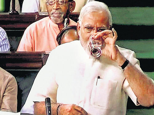 Prime Minister Narendra Modi takes a pause to drink water during the discussion on President's address in the Rajya Sabha in New Delhi on Wednesday. PTI