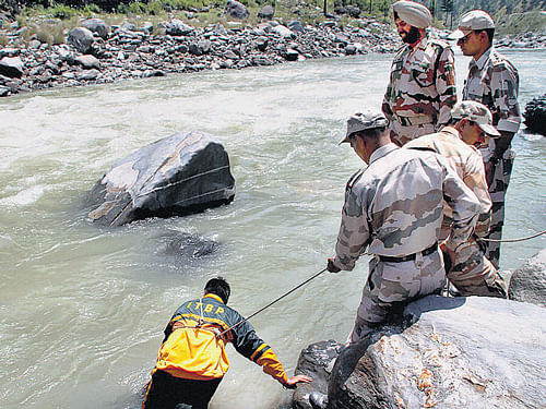 ITBP personnel carry out search operations for the missing students in the Beas river on Wednesday. PTI