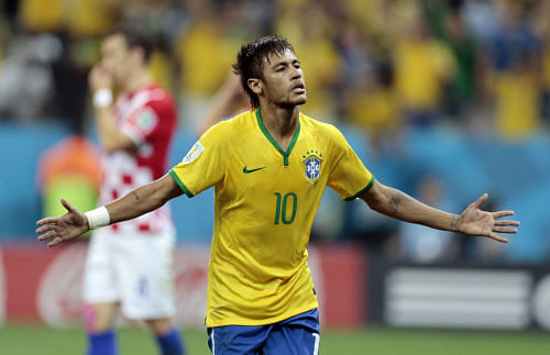 Brazil's Neymar celebrates his second goal on a penalty kick during the group A World Cup soccer match between Brazil and Croatia, the opening game of the tournament, in the Itaquerao Stadium in Sao Paulo, Brazil, Thursday, June 12, 2014. (AP Photo)