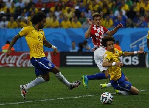 Brazil's Marcelo scores an own goal as Croatia's Nikica Jelavic and Brazil's David Luiz look on during the 2014 World Cup opening match between Brazil and Croatia at the Corinthians arena in Sao Paulo. Reuters photo