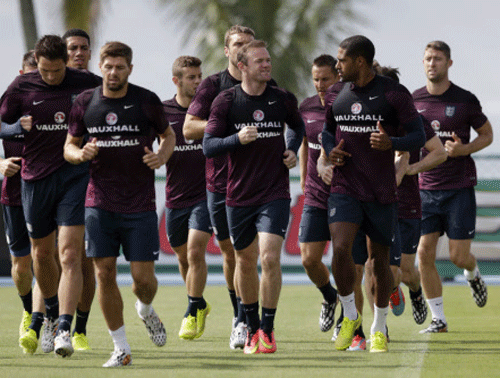 England national soccer team players, at front from left, Frank Lampard, captain Steven Gerrard, Wayne Rooney and Glen Johnson take part in a squad training session for the 2014 soccer World Cup at the Urca military base in Rio de Janeiro, Brazil. AP photo