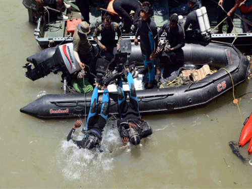 Divers jump into the Bhakra Beas Management Board lake to search for missing Hyderabad-based engineering students during a rescue operation in Mandi. The bodies of two more victims of the Beas river tragedy reached Hyderabad on Friday. PTI photo