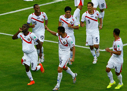 Costa Rica's Joel Campbell (9) celebrates with teammates after scoring a goal against Uruguay during their 2014 World Cup Group D soccer match at the Castelao arena in Fortaleza June 14, 2014. REUTERS