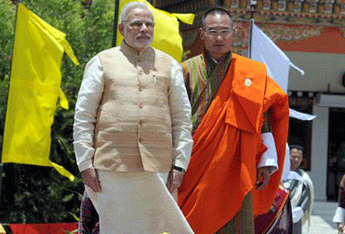 Prime Minister Narendra Modi with his Bhutanese counterpart Tshering Tobgay during a ceremonial welcomed on his arrival at the Paro International Airport in Bhutan on Sunday. PTI photo