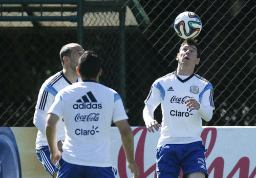 Argentina's Lionel Messi heads the ball during a training session in Vespasiano, near Belo Horizonte, Brazil. AP photo