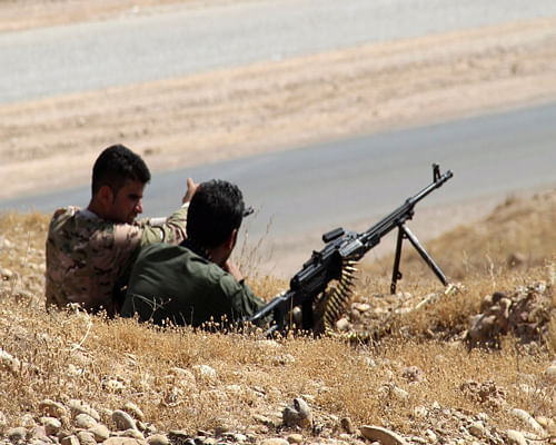 Kurdish forces took control of a border crossing point with Syria, as Iraqi security forces fought insurgent groups trying to seize an ethnically mixed city in the country's northern province of Nineveh, military sources said Sunday. Reuters photo
