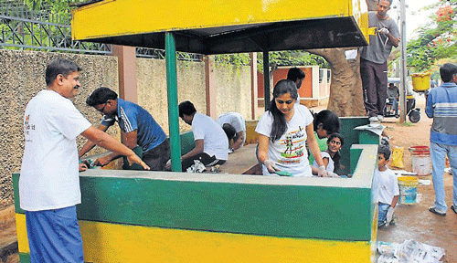 Volunteers of Let's Do it!, Mysore, beautify one of the bus shelters during their recent campaign, in Mysore.